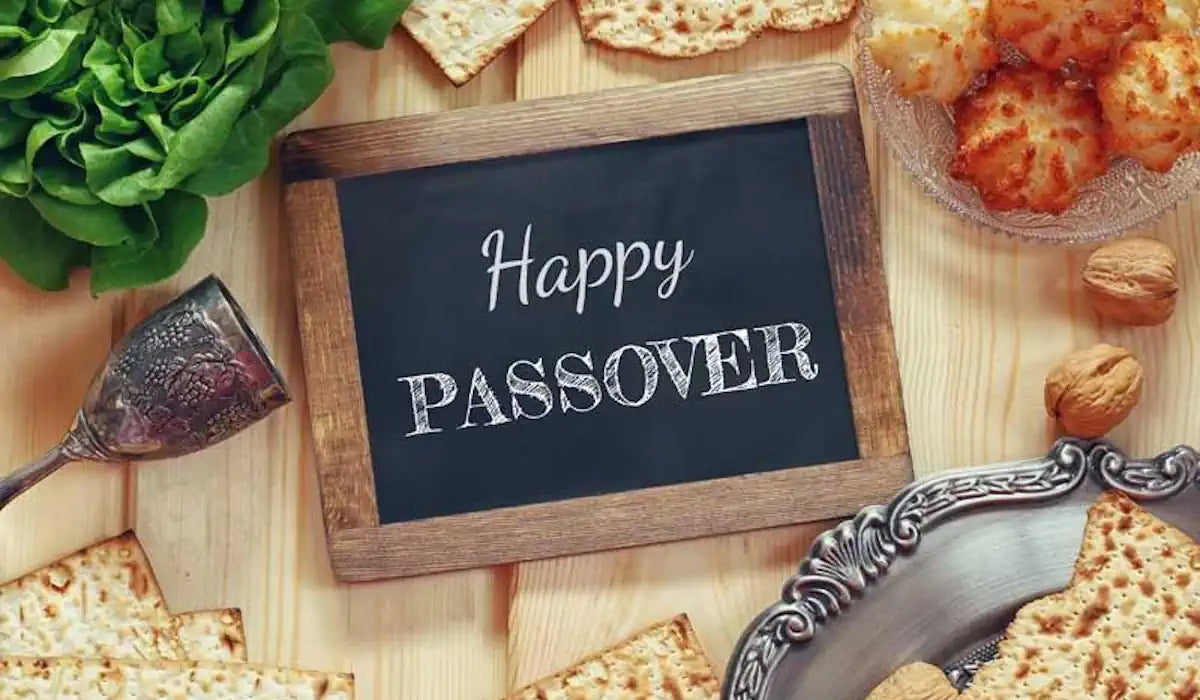 a sign that reads Happy Passover surrounded by matzah, macaroons, and lettuce