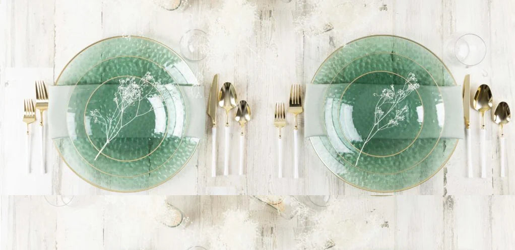 2 plates settings of green dishes set with gold flatware with white handles