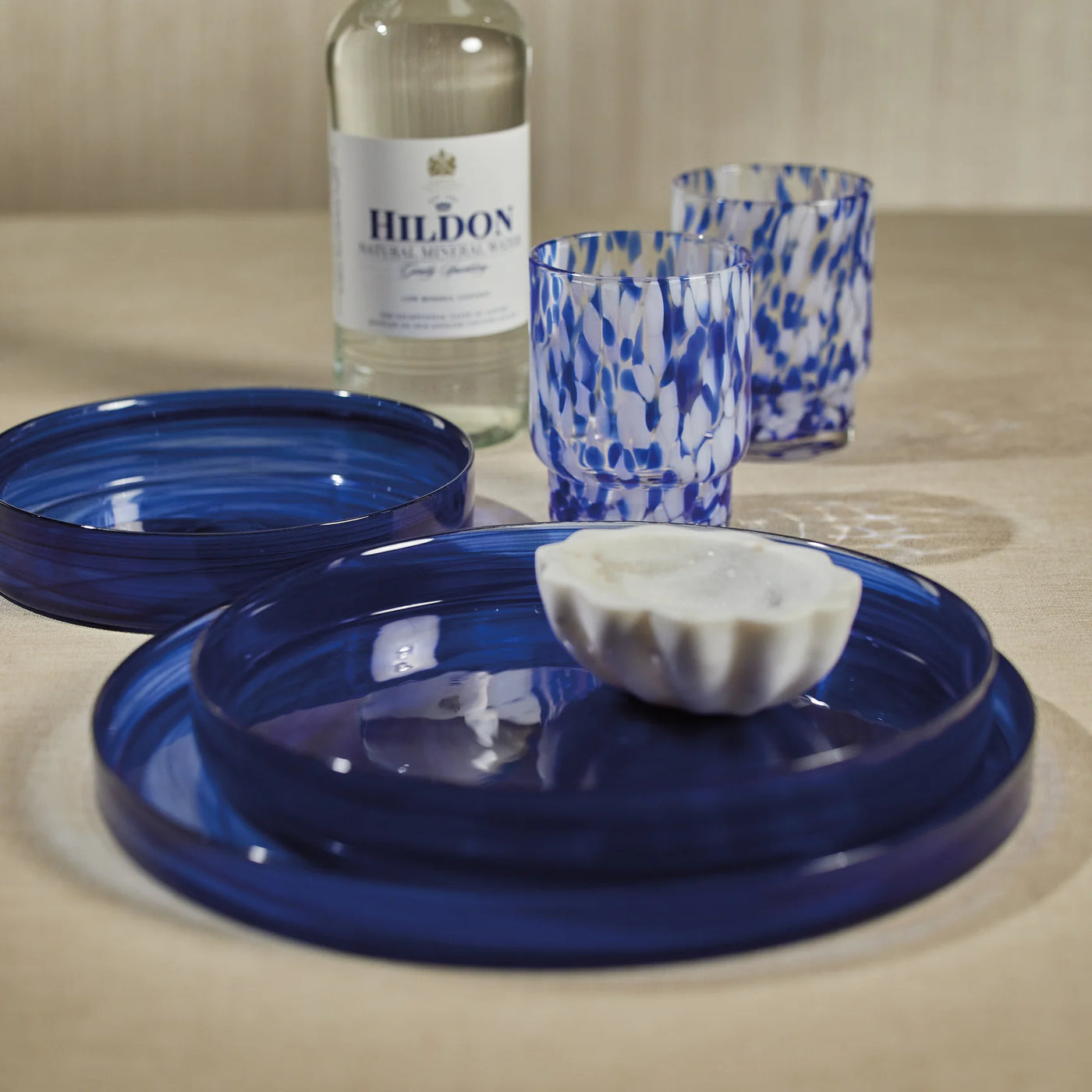 An elegant medium-sized indigo blue alabaster glass tray with subtle veining, perfect for serving appetizers or desserts